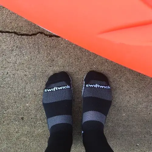 Swiftwick socks on wet cement and boat
